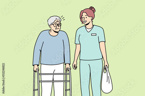 Woman health care worker helps elderly disabled person with walking frame. Medical professional carries bag of physically handicapped old man with walker. Vector line art multicolored illustration.