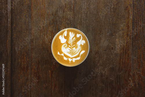 a cup of latte art coffee on wooden background 