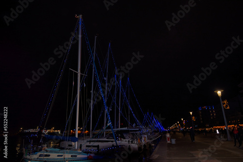 Beautiful seaside town at night, Christmas and New Year festive season, Volos, Greece ,Sail Boat Holiday Lights, decorated city for the Christmas holidays,