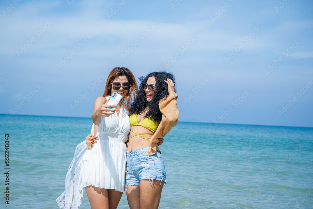 Two women in summer casual clothes play in the sea on vacation,Concept vacation,Holiday in summer.