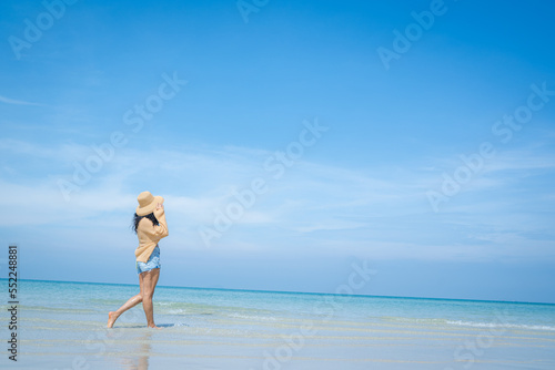 Happy carefree woman enjoying beautiful sea on the beach,Summer holidays concept.