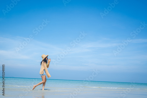 Happy woman playful on paradise tropical beach having fun in freedom Beautiful girl on travel vacation.
