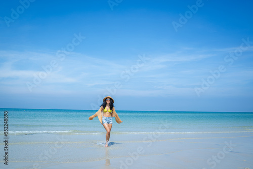 Happy woman playful on paradise tropical beach having fun in freedom,Beautiful girl on travel vacation.
