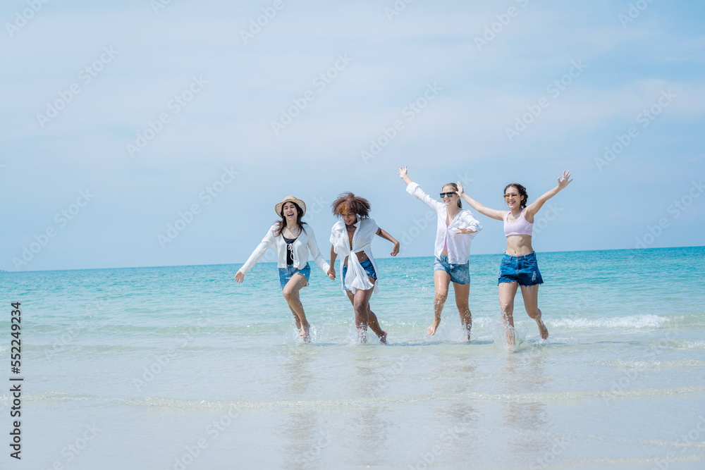 People spending time at the beautiful beach,Happy female friends enjoy activity on holiday travel vacation at the sea,Having Fun,Summer Lifestyle,Nice weather in travel and holiday concept.