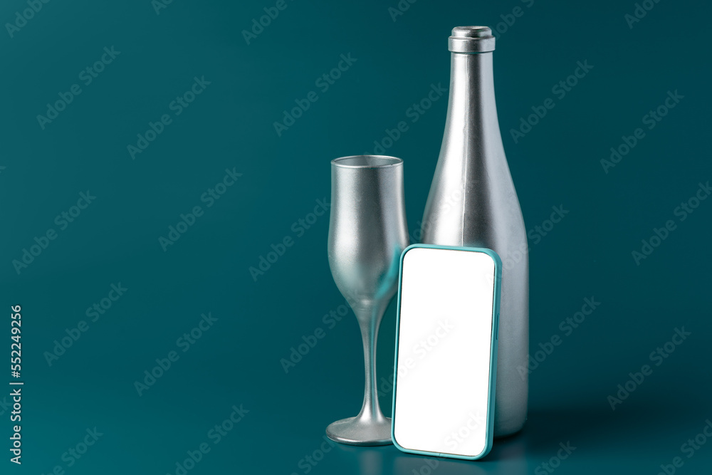 Beautiful picture of a bottle of champagne and glass on dark green background Beautiful picture of a bottle of champagne and glass on dark green background