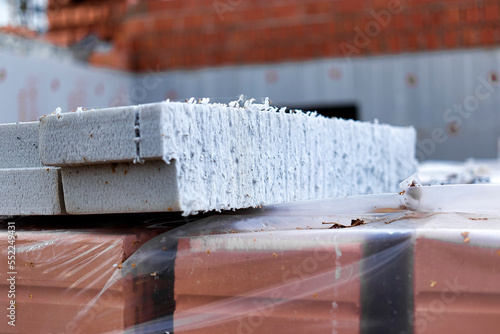 Wall insulation with polystyrene foam. Insulation and waterproofing of the underground part of the building. Wall protection and heat preservation in the house. Insulation of the facade of the house. photo