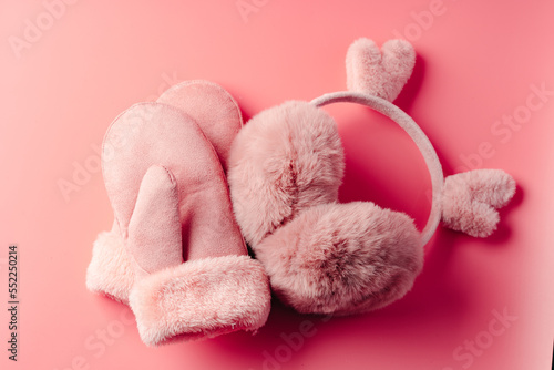 Pink mittens against pink background studio shot