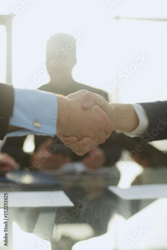 business partners shaking hands with the applause of the business team .