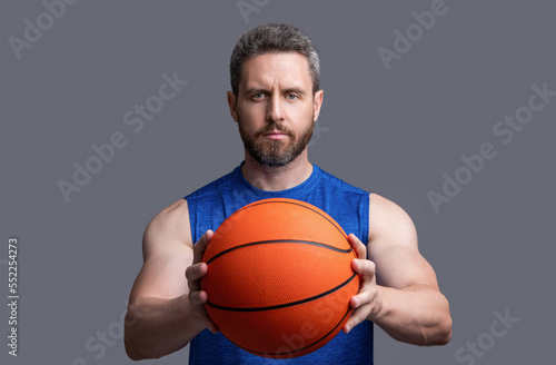 sportive athlete man basketball player isolated on grey background. athlete man basketball player