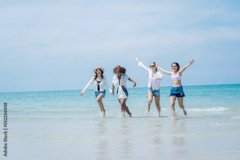 People spending time at the beautiful beach,Happy female friends enjoy activity on holiday travel vacation at the sea,Having Fun,Summer Lifestyle,Nice weather in travel and holiday concept.
