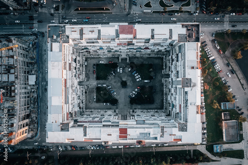 Modern house or building in square shape with palace well inside, aerial top view from drone