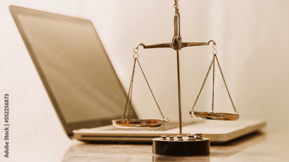Business and lawyers discussing contract papers with brass scale on desk in office. Law, legal services, advice, justice and law concept picture with film grain effect Business and lawyers discussing contract papers with brass scale on desk in office. Law, legal services, advice, justice and law concept picture with film grain effect