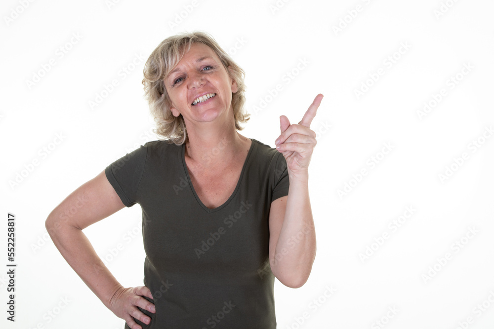 senior woman blonde middle aged pointing fingers aside copy space on white background senior woman blonde middle aged pointing fingers aside copy space on white background