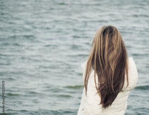 Woman looking at the lake of Leucate, Languedoc-Roussillon, France. Lake of Salses between the departments of Pyrénées-Orientales and Aude in Occitania. 