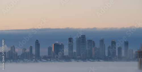 A thick fog blanket covering Metro Vancouver on a winter morning during sunrise in Burnaby, British Columbia, Canada © StandbildCA