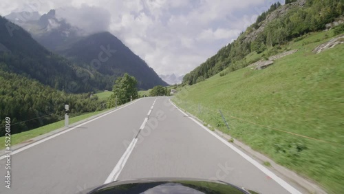 Driving on the Sustenpass in Switzerland. The alpine landsacape filmed from the car point of view. The susten is a famous pass road in the swiss alps. First Person view of a beautiful mountain range. photo