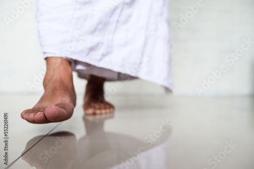 Muslim man enters the holy mosque with his right foot first