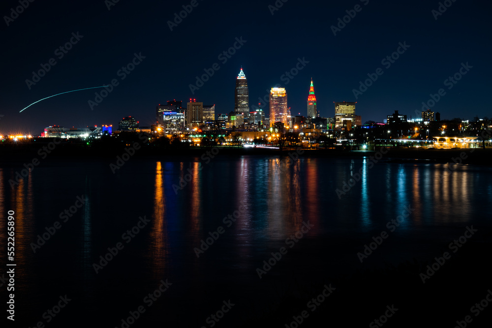 Colorful city lights at night over Lake Erie.