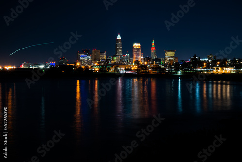 Colorful city lights at night over Lake Erie.
