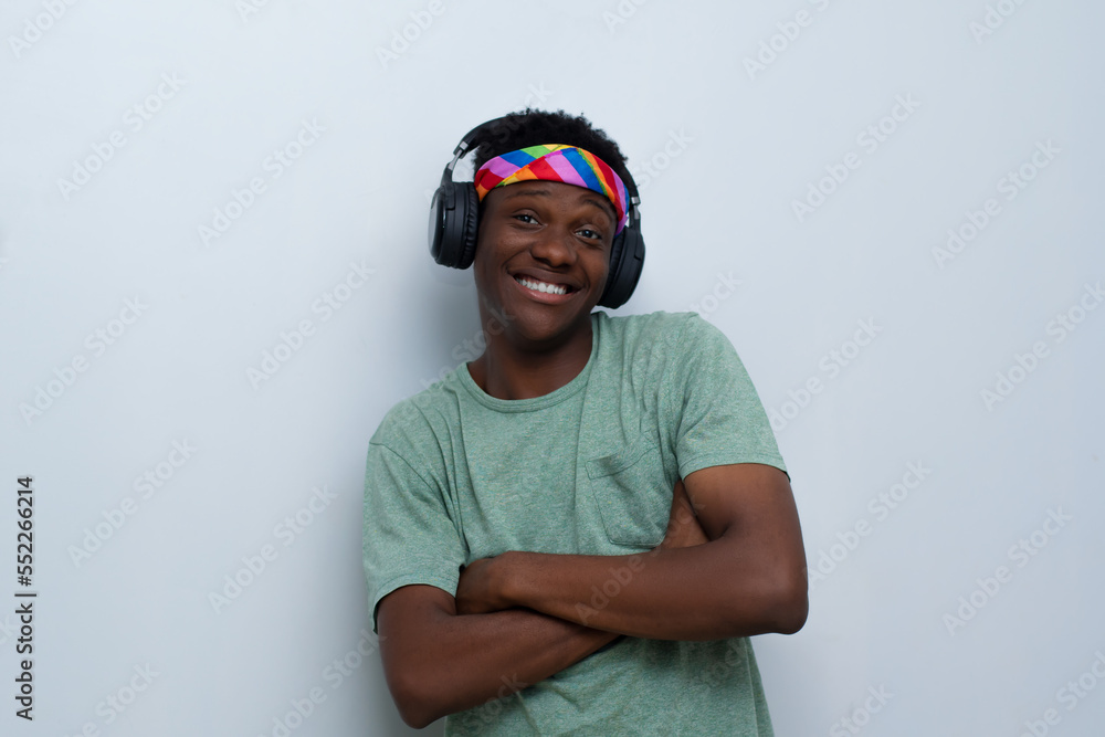 Fototapeta premium young handsome man wearing shirt listening to music on an headphone