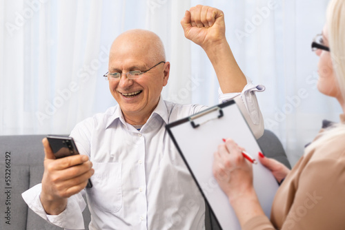 Psychology . Elderly adult man consulting with psychologist, psychiatrist with elderly, old patient counseling mental with doctor taking notes at clinic. Encouraging, therapy.