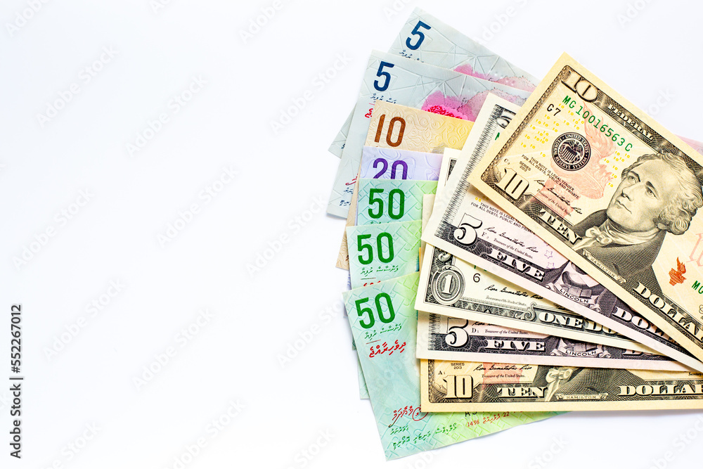 Maldives banknotes and dollar banknotes arranged in a chaotic manner. Group of money maldives and dollar banknotes on a white background and space for text. Exchange money, travel concept. Maldives banknotes and dollar banknotes arranged in a chaotic manner. Group of money maldives and dollar banknotes on a white background and space for text. Exchange money, travel concept.