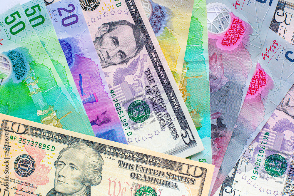 Maldives banknotes and dollar banknotes arranged in a chaotic manner. Group of money maldives and dollar banknotes on a white background and space for text. Exchange money, travel concept. Maldives banknotes and dollar banknotes arranged in a chaotic manner. Group of money maldives and dollar banknotes on a white background and space for text. Exchange money, travel concept.