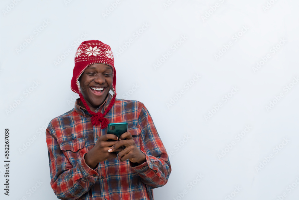 young african man excited with the news he saw on his phone young african man excited with the news he saw on his phone