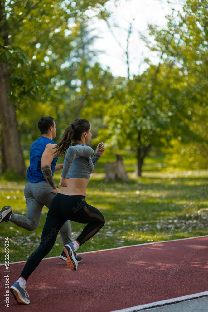 Male and female friends running together Male and female friends running together