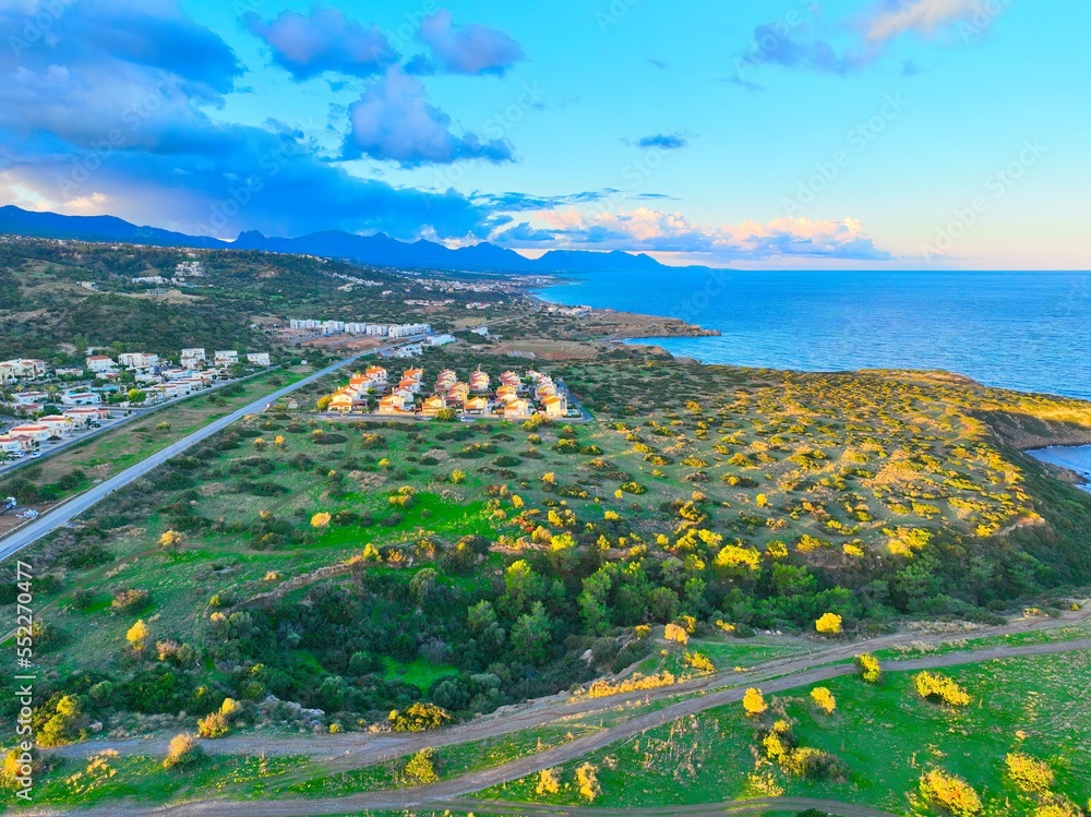 Obraz premium Sunset with green field which is land for real estate in Esentepe, North Cyprus