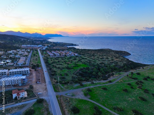 Sunset with green field which is land for real estate in Esentepe, North Cyprus photo