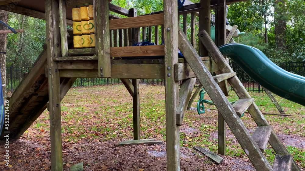 Old creepy looking outdoor jungle gym playset in yard with swing and slide Old creepy looking outdoor jungle gym playset in yard with swing and slide