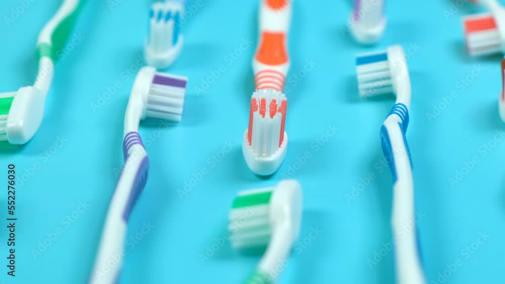 background dental toothbrushes of different colors on a blue background top view background dental toothbrushes of different colors on a blue background top view