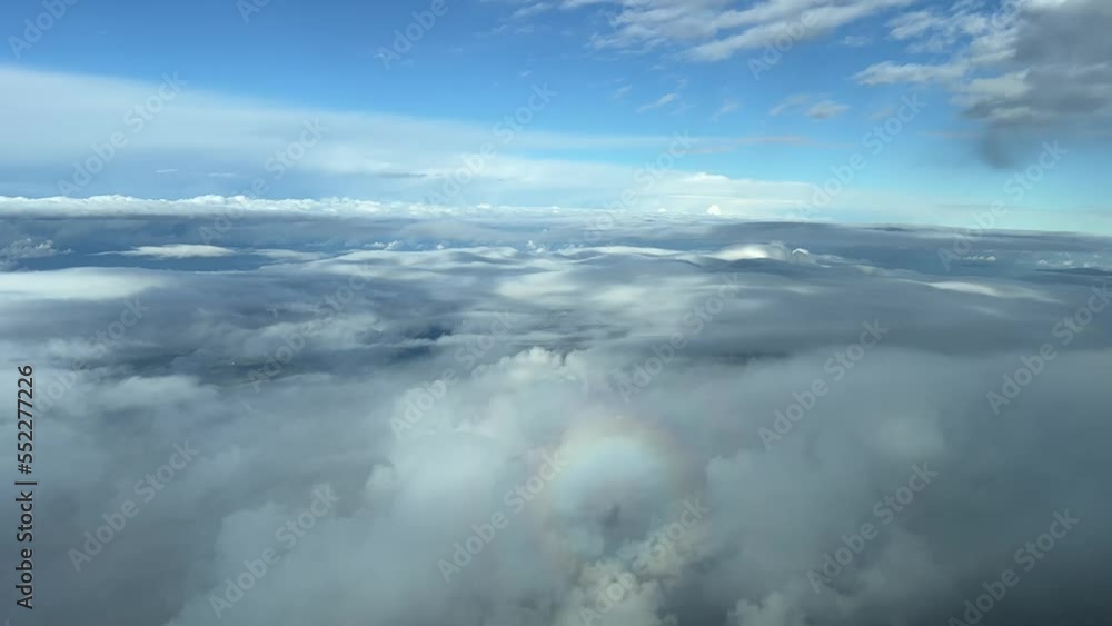Pilot point of view from a jet cockpit overflying stratus and cumulus in a cold winter sky with tha halo of the plane in front. 4k Pilot point of view from a jet cockpit overflying stratus and cumulus in a cold winter sky with tha halo of the plane in front. 4k