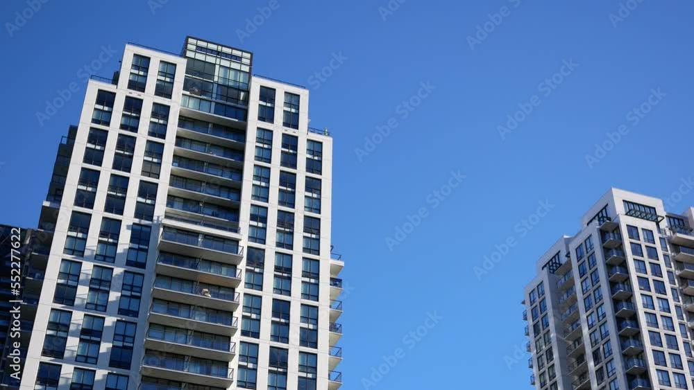 The motion of high-rise residential new buildings on blue sky with 4k resolution The motion of high-rise residential new buildings on blue sky with 4k resolution