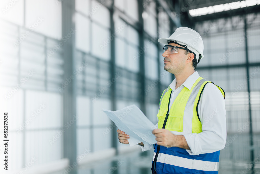 warehouse manager with tablet and ..radio communication his worker working in background in warehouse distribution center environment. Business warehouse inventory,contruction warehouse warehouse manager with tablet and ..radio communication his worker working in background in warehouse distribution center environment. Business warehouse inventory,contruction warehouse