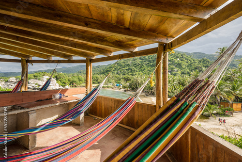 Accommodation in tower at Carbo San Juan in Tayrona National Park. Caribbean beach with quiet, relaxing, colorful hammock view in South America, Colombia. Discover the jungle and the palm trees photo