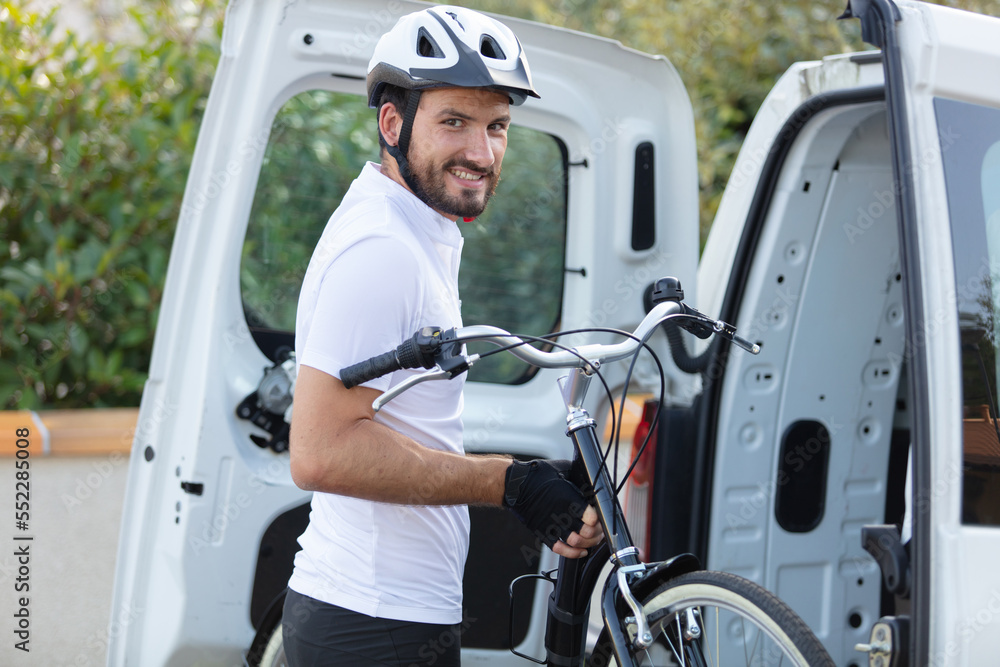man put his bicycle in the trunk of a car man put his bicycle in the trunk of a car