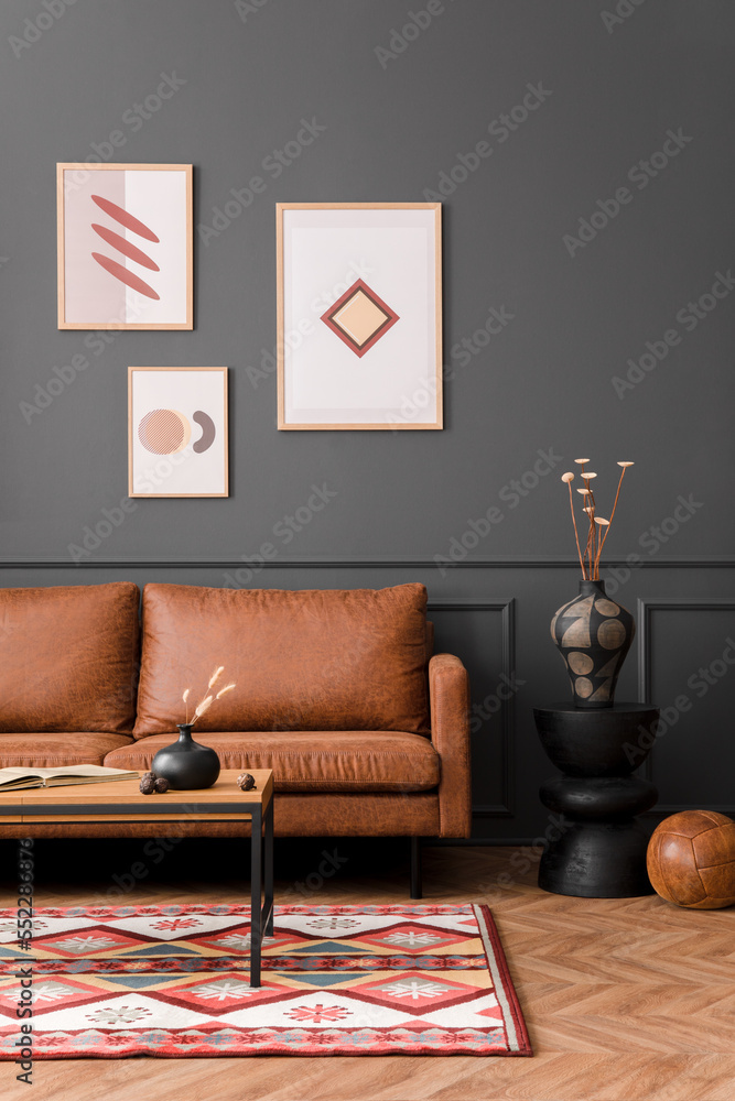 Aesthetic Interior Of Living Room With Mock Up Poster Frame Brown Sofa Wooden Coffee Table Black Lamp Patterned Rug Gray Wall Plants In Flowerpot And Personal Accessories Home Decor Template Photos