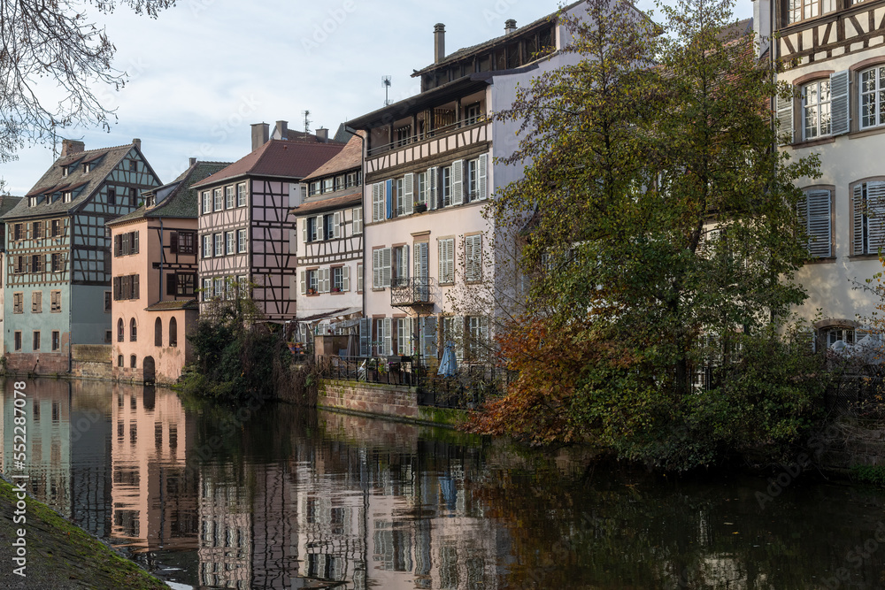 View over the river Ill to an old row of half-timbered houses in Petit France in winter in Strasbourg, France