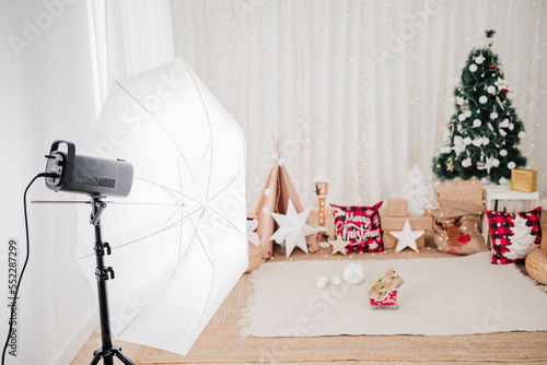 close up of photography studio set up of christmas decoration. star, lights, christmas tree, gifts and ornaments