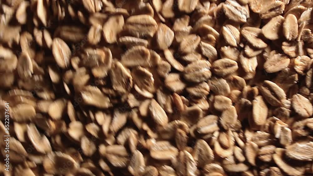 Oat Flakes Background Rotating Counter-Clockwise - Top View, Low Key Light. Scattered Dry Oat Flakes. Healthy Breakfast and Diet Eating Ingredients - Angular Rotation Left Oat Flakes Background Rotating Counter-Clockwise - Top View, Low Key Light. Scattered Dry Oat Flakes. Healthy Breakfast and Diet Eating Ingredients - Angular Rotation Left
