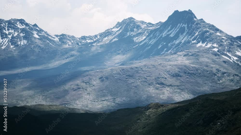 Aerial Over Valley With Snow Capped Mountains In Distance Aerial Over Valley With Snow Capped Mountains In Distance