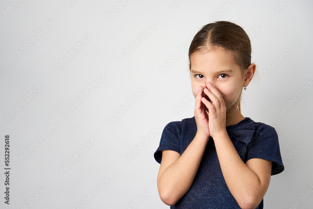 Little girl covering her mouth with her hands Little girl covering her mouth with her hands