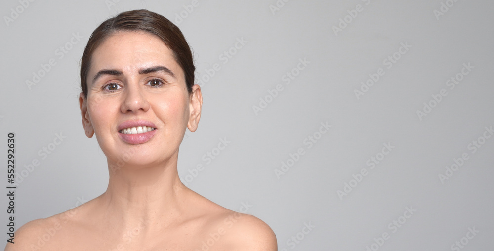 Middle Aged Woman White Background. Female 40 Year Lady Looking At Camera Smiling. Concept of Enjoying Her natural beauty, High Self Esteem, Wellness. Natural Cosmetic Skincare Products. Middle Aged Woman White Background. Female 40 Year Lady Looking At Camera Smiling. Concept of Enjoying Her natural beauty, High Self Esteem, Wellness. Natural Cosmetic Skincare Products.