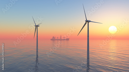 Offshore Windkraftanlagen und Frachter bei Sonnenuntergang