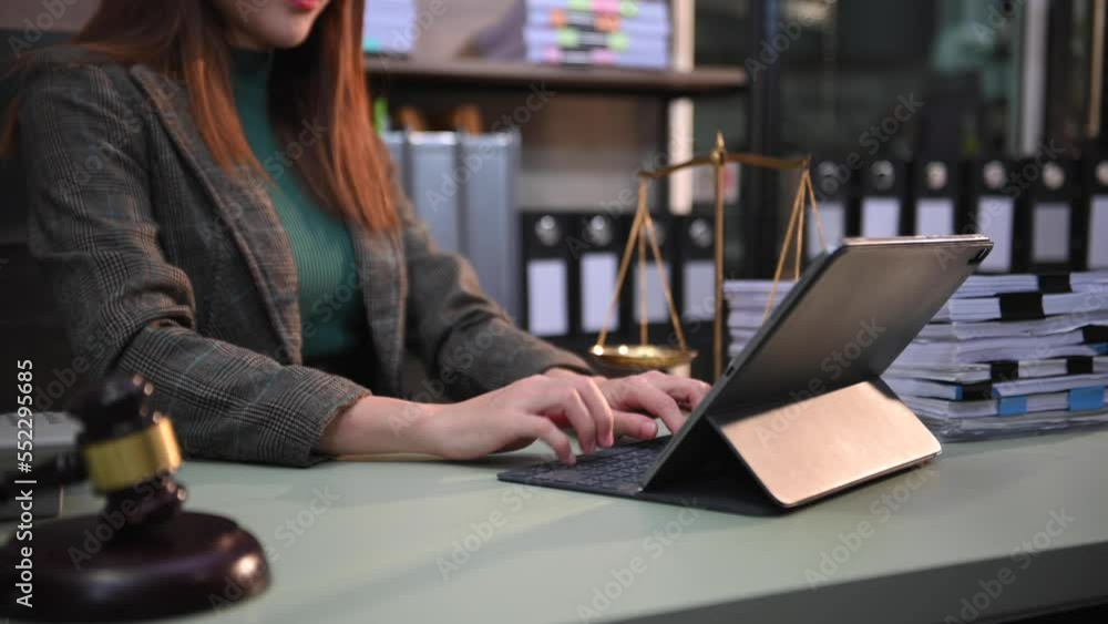 justice and law concept.Male judge in a courtroom the gavel, working with smart phone and laptop and digital tablet computer on wood table justice and law concept.Male judge in a courtroom the gavel, working with smart phone and laptop and digital tablet computer on wood table