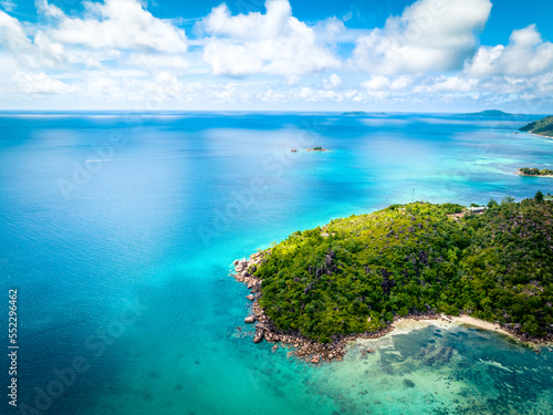 Praslin Seychelles tropical island with withe beaches and palm trees. Aerial view of tropical paradise bay with granite stones and turquoise crystal clear waters of Indian Ocean © Alexey Oblov