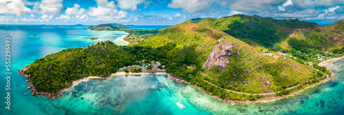 Praslin Seychelles tropical island with withe beaches and palm trees. Aerial view of tropical paradise bay with granite stones and turquoise crystal clear waters of Indian Ocean photo
