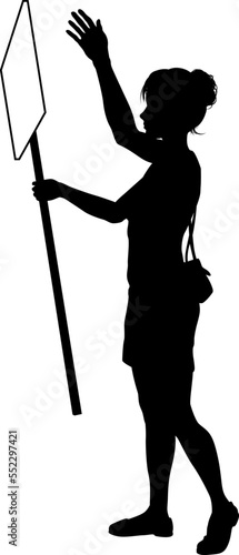 Protestor or demonstrator at a demonstration march, picket line or strike protest rally in silhouette. Holding up a banner or picket sign board placard.